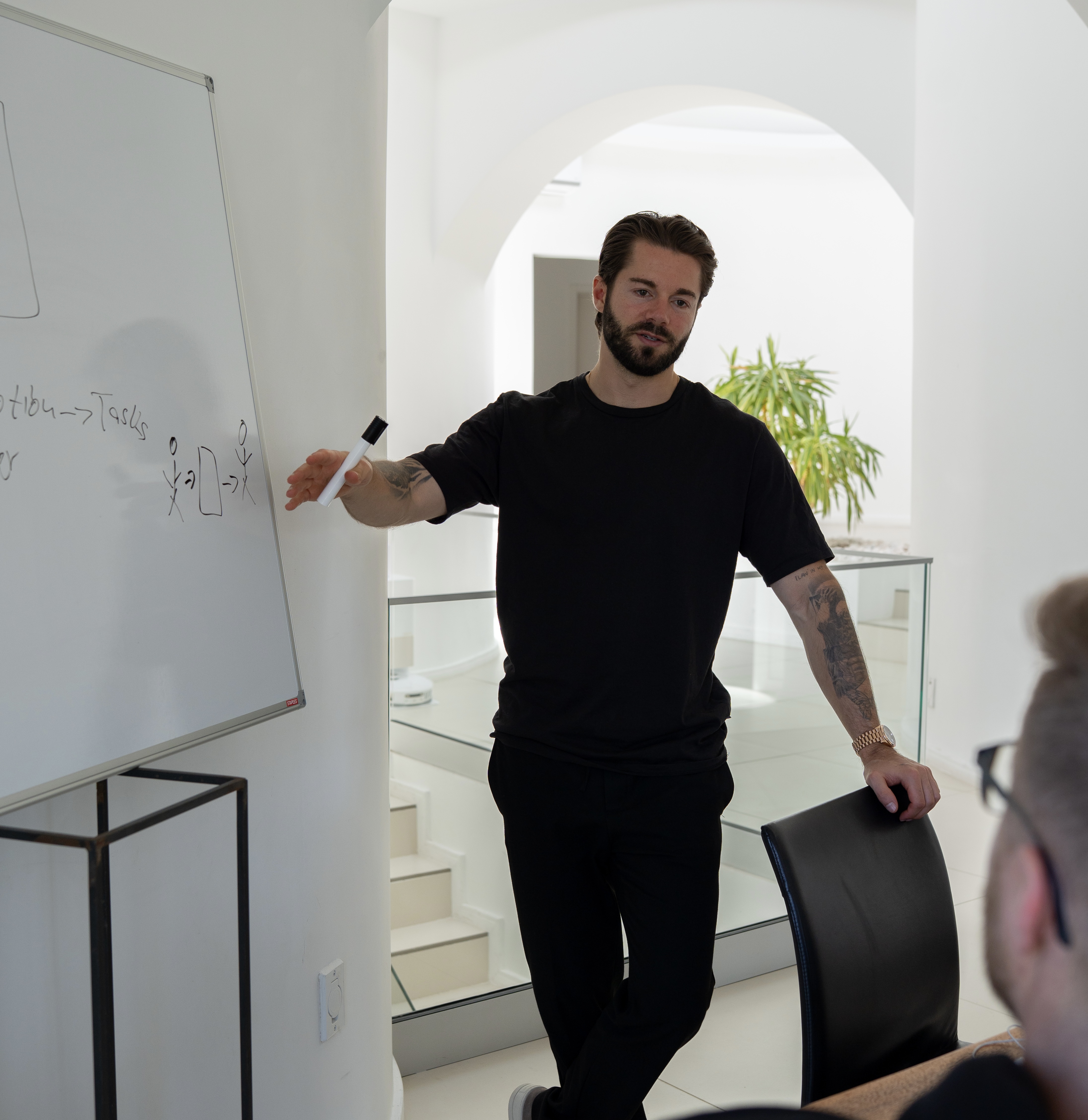 Jascha working through a system on a whiteboard with a client